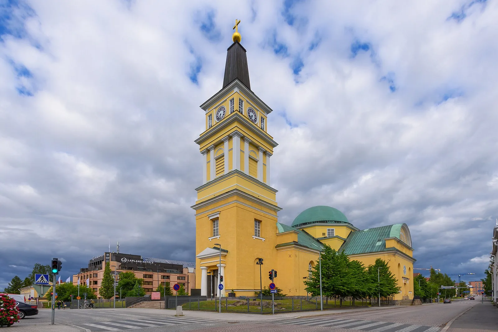 Keltainen tuomiokirkko torneineen ja kupoleineen pilvisellä taivaalla